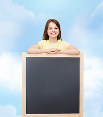 Image showing happy little girl with blank blackboard