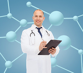 Image showing smiling male doctor with clipboard and stethoscope