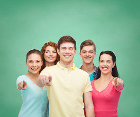 Image showing group of smiling teenagers over green board