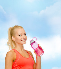 Image showing smiling sporty woman with water bottle