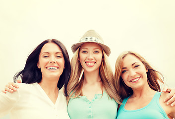 Image showing group of smiling girls chilling on the beach