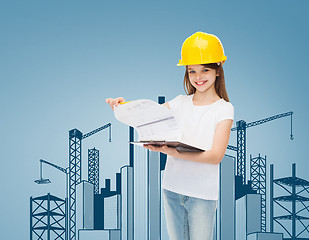 Image showing smiling little girl in hardhat with clipboard