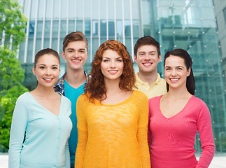 Image showing group of smiling teenagers over city background