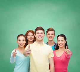 Image showing group of smiling teenagers over green board