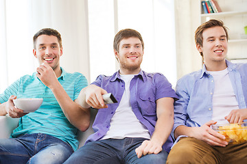 Image showing happy male friends watching tv at home