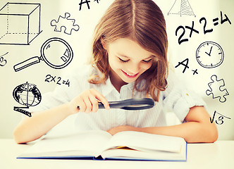 Image showing girl reading book with magnifier at school