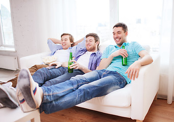 Image showing happy male friends with beer watching tv at home