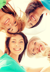 Image showing faces of girls looking down and smiling