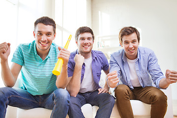 Image showing happy male friends with vuvuzela