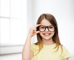 Image showing smiling cute little girl in black eyeglasses