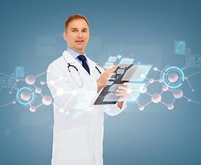 Image showing smiling male doctor with clipboard and stethoscope