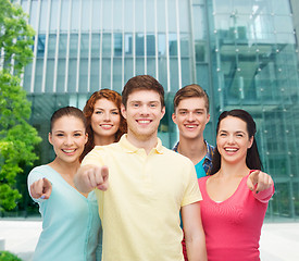 Image showing group of smiling teenagers over city background