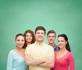 Image showing group of smiling teenagers over green board