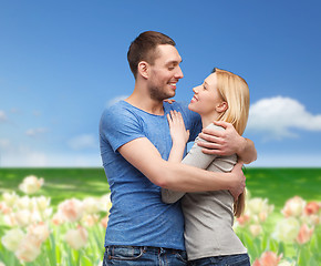 Image showing smiling couple hugging and looking at each other