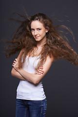 Image showing Woman posing with hair fluttering in the wind