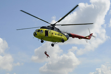 Image showing The yellow MI-8 helicopter hanged with an open door. Landing of 