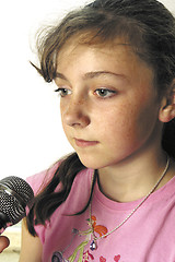 Image showing Young girl with karaoke microphone