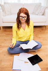 Image showing smiling teenage girl with tablet pc at home