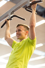 Image showing smiling man exercising in gym