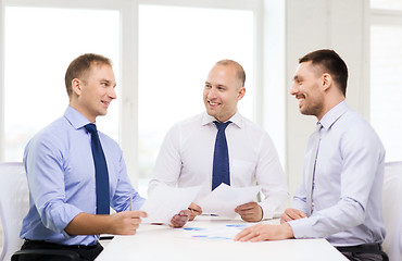 Image showing smiling businessmen with papers in office