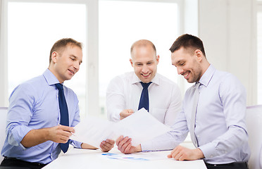 Image showing smiling businessmen with papers in office