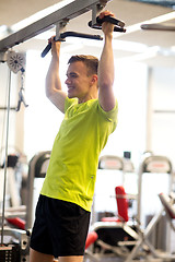 Image showing smiling man exercising in gym