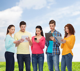 Image showing group of teenagers with smartphones and tablet pc