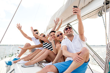 Image showing smiling friends sitting on yacht deck