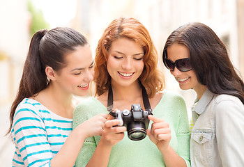 Image showing smiling teenage girls with camera