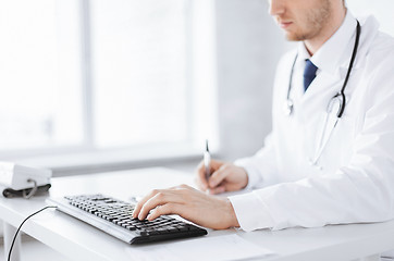 Image showing male doctor typing  on the keyboard
