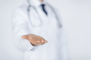 Image showing male doctor holding something in his hand