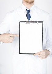 Image showing doctor pointing at blank white paper