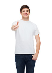 Image showing smiling man in white t-shirt showing thumbs up