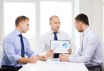 Image showing serious businessmen with papers in office