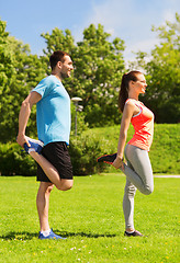 Image showing smiling couple stretching outdoors