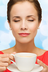 Image showing smiling woman in red dress with cup of coffee