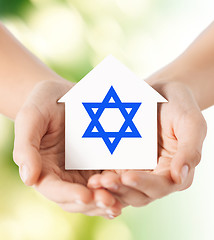 Image showing close up of hands holding house with star of david