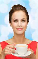 Image showing smiling woman in red dress with cup of coffee