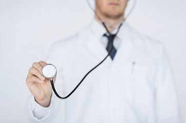 Image showing doctor hand with stethoscope listening something