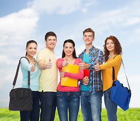 Image showing group of smiling teenagers showing thumbs up