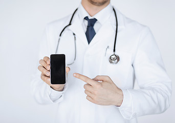 Image showing doctor pointing at smartphone