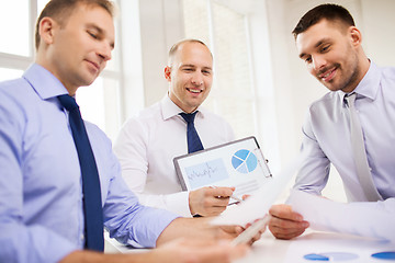 Image showing smiling businessmen with papers in office