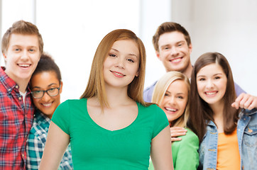 Image showing group of smiling teenagers over classroom