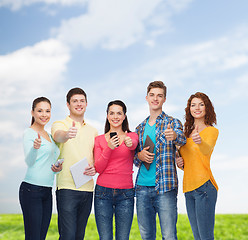 Image showing group of teenagers with smartphones and tablet pc