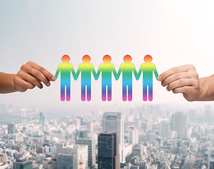 Image showing close up of hands holding paper chain gay people