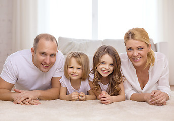 Image showing parents and two girls lying on floor at home