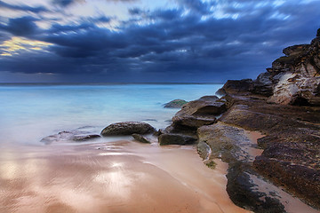 Image showing Stunning beach and coastal rocks before sunrise