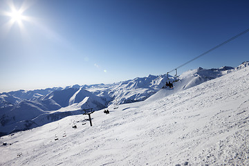 Image showing Ski slope and blue sky with sun