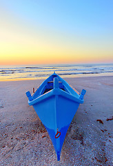 Image showing fishing boat on the seashore at sunrise