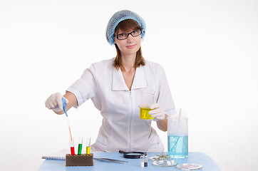 Image showing Chemist gaining liquid from a test tube